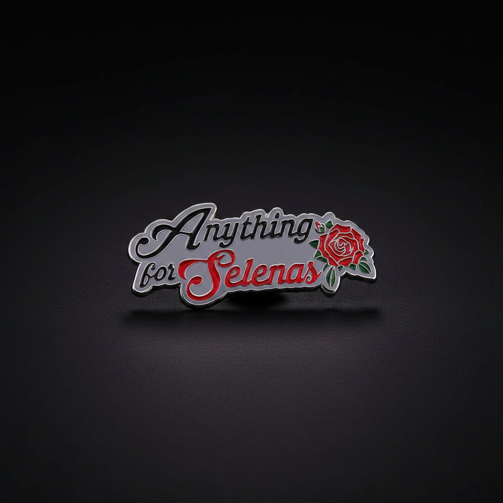 Anything For Selenas Enamel Pin from Brujita Charms, a silver metal enamel pin that states "Anything for Selenas" with a red rose. It is a nod to Selena Quintanilla, a Mexican-American pop star. The pin sits on a dark background.