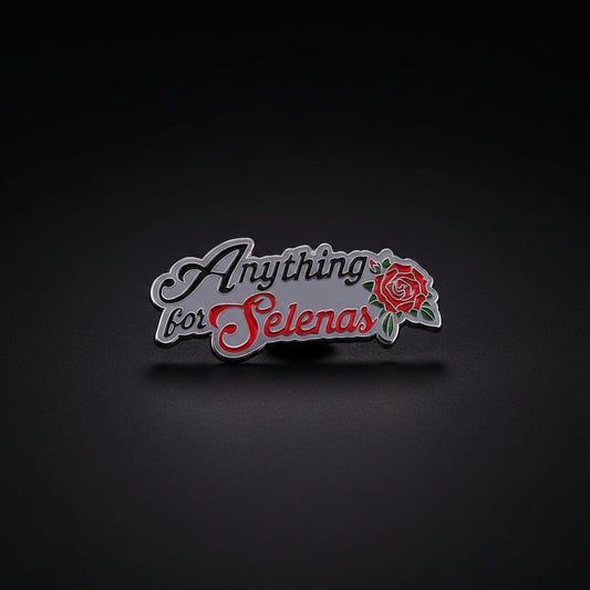 Anything For Selenas Enamel Pin from Brujita Charms, a silver metal enamel pin that states "Anything for Selenas" with a red rose. It is a nod to Selena Quintanilla, a Mexican-American pop star. The pin sits on a dark background.