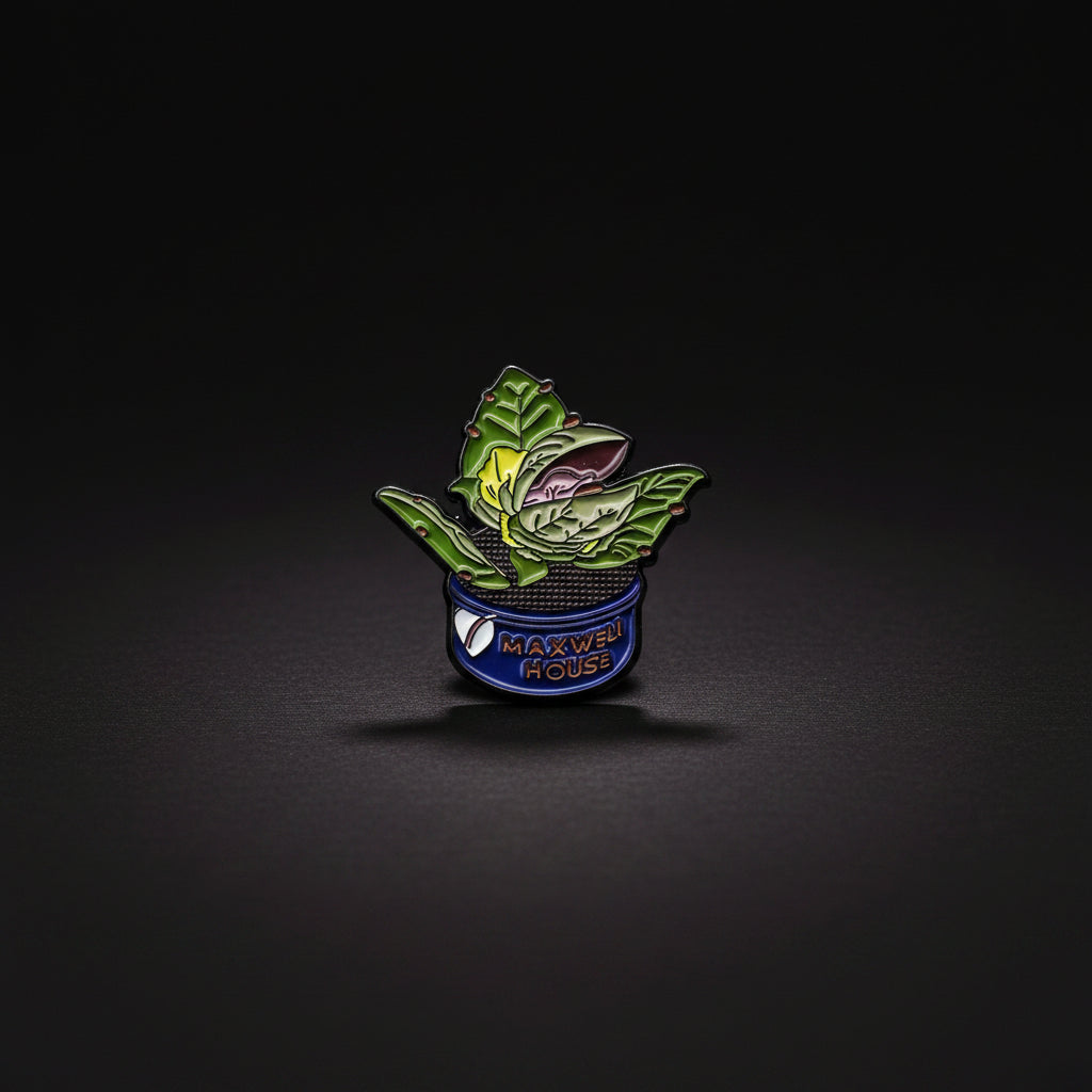Enamel pin of a small Audrey II, our favorite man -eating plant from the cult classic Little Shop of Horrors.