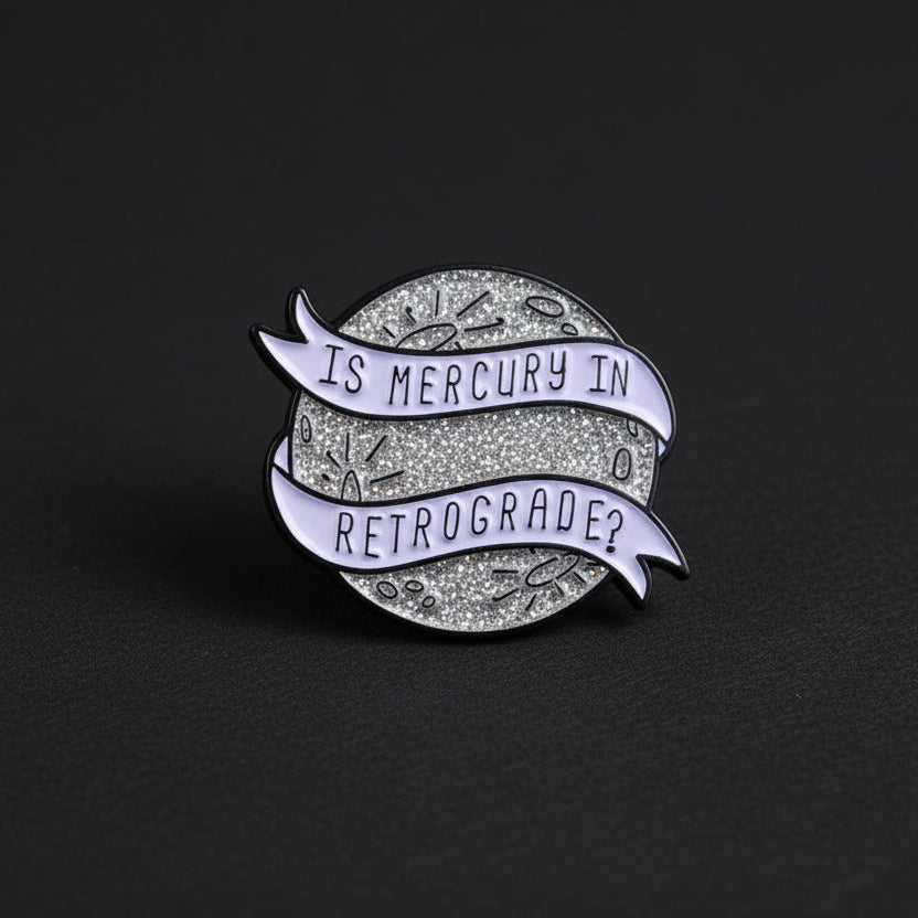 mercury retrograde enamel pin design
astrology enamel pin on dark background
mercury retrograde pin close up detail
cosmic enamel pin worn on jacket