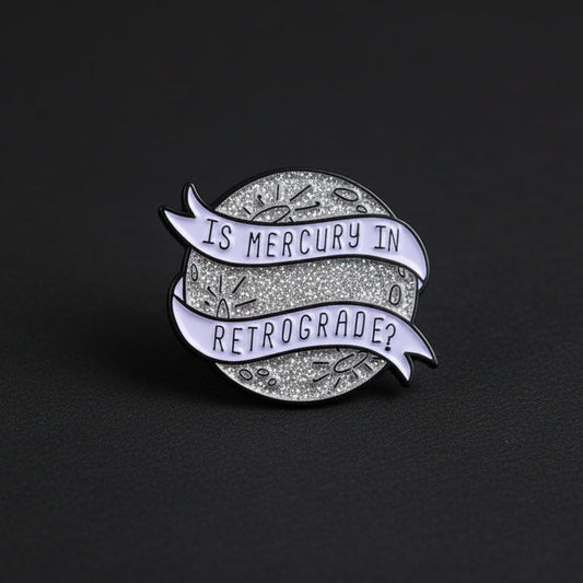 mercury retrograde enamel pin design
astrology enamel pin on dark background
mercury retrograde pin close up detail
cosmic enamel pin worn on jacket