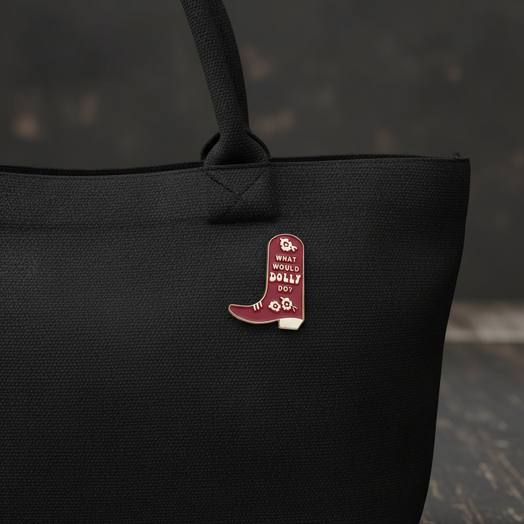A burgundy cowboy boot pin with the words "What would Dolly do?" and a floral pattern.