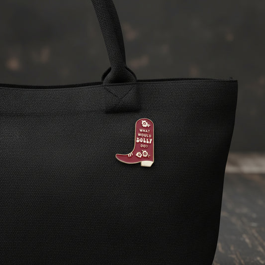 A burgundy cowboy boot pin with the words "What would Dolly do?" and a floral pattern.